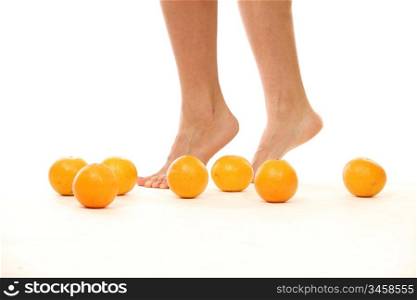 leg and oranges isolated white background