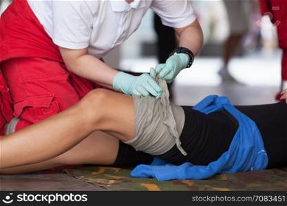 Leg bandaging. Paramedic in action.