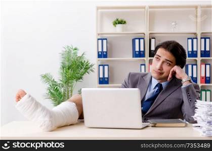Leg injured employee working in the office 
