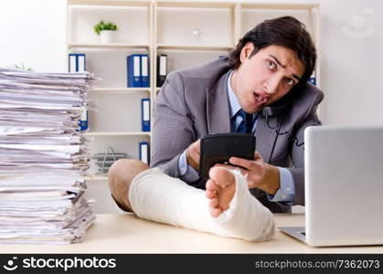 Leg injured employee working in the office 