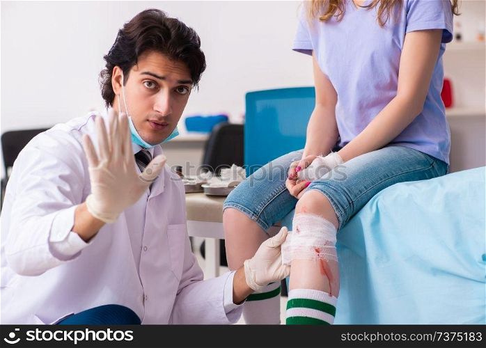 Leg injured young woman visiting male doctor 