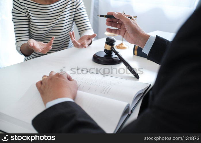 Legal counsel presents to the client a signed contract with gavel and legal law. justice and lawyer concept