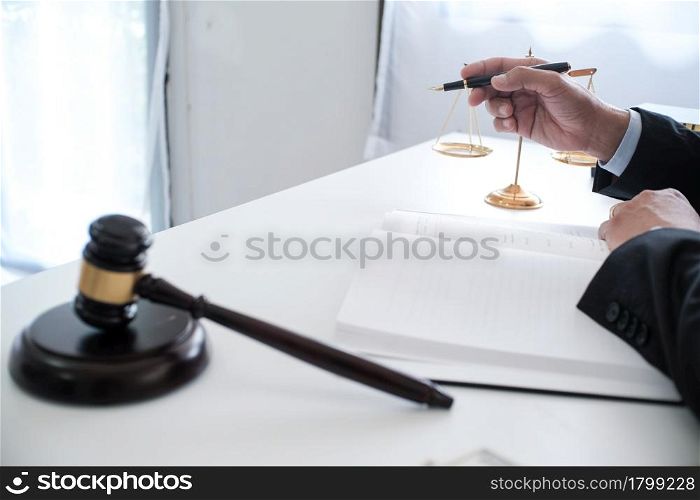 Legal counsel presents to the client a signed contract with gavel and legal law. justice and lawyer concept