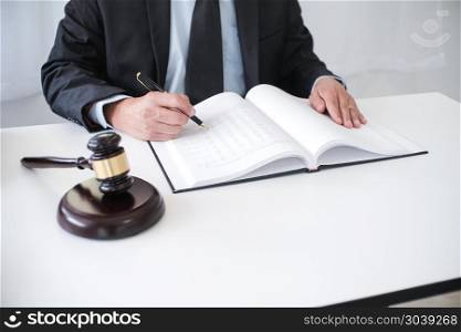 Legal counsel presents to the client a signed contract with gavel and legal law. justice and lawyer concept. Legal counsel presents to the client a signed contract with gave