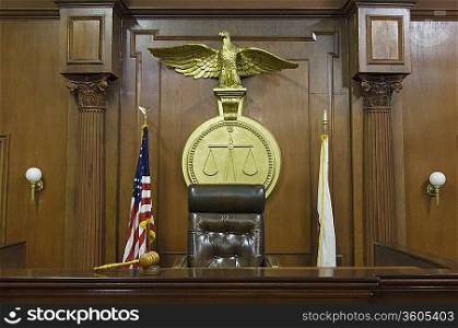 Legal scales behind judges chair in court