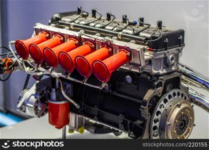 Legendary Motorsport engine with red pipes on throttles