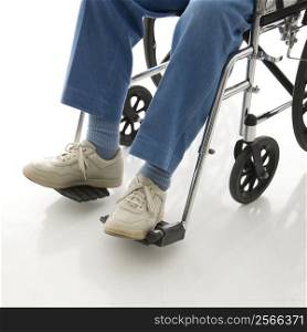 Legs and feet of elderly man sitting in wheelchair.