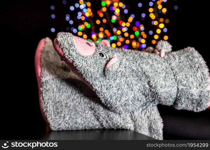 Legs in winter Christmas socks on blurred lights