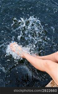 Legs splashing in lake