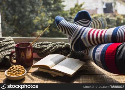 legs striped socks near window . Resolution and high quality beautiful photo. legs striped socks near window . High quality and resolution beautiful photo concept