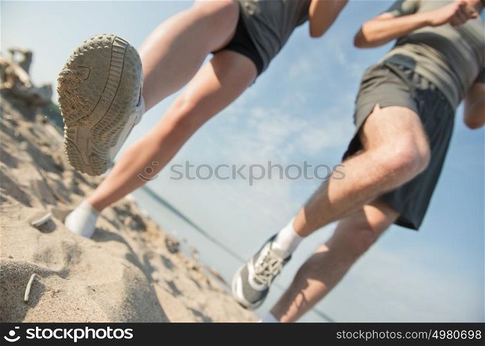 Legs View Of A Couple Jogging Outdoor on the Beach