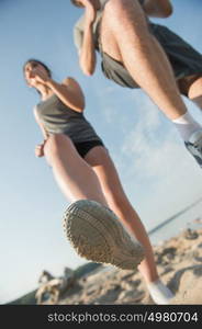 Legs View Of A Couple Jogging Outdoor on the Beach