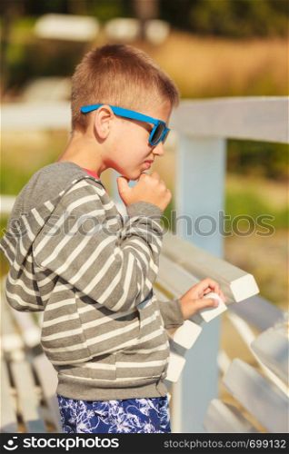 Leisure and free time concept. Portrait of little boy spending time outside on fresh air. Male kid outdoor on holidays vacation.. Portrait of boy outdoor in summer time.