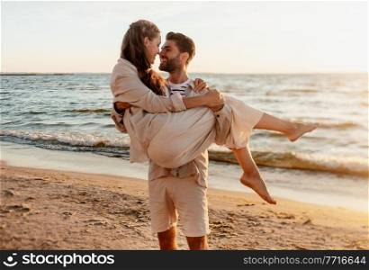 leisure and people concept - happy couple having fun on summer beach. happy couple having fun on summer beach