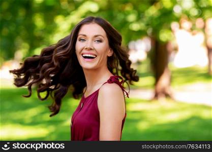 leisure and people concept - happy smiling woman at summer park. happy smiling woman at summer park
