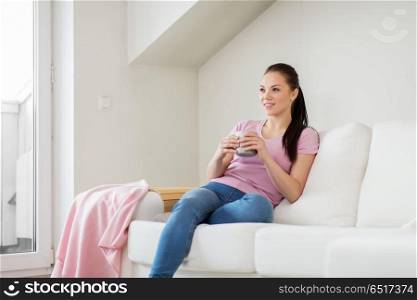 leisure and people concept - happy woman or housewife drinking coffee at home. happy woman or housewife drinking coffee at home. happy woman or housewife drinking coffee at home