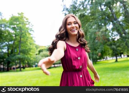 leisure and people concept - portrait of happy smiling beautiful woman with long wavy hair at summer park. portrait of happy smiling woman at summer park