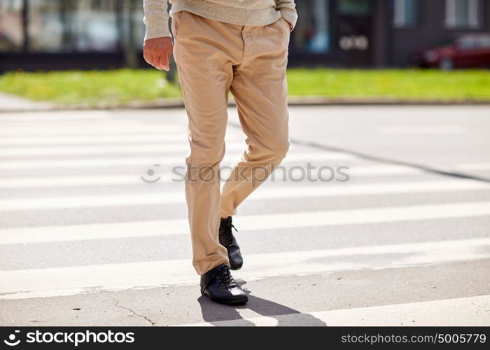 leisure and people concept - senior man walking along summer city crosswalk. senior man walking along city crosswalk