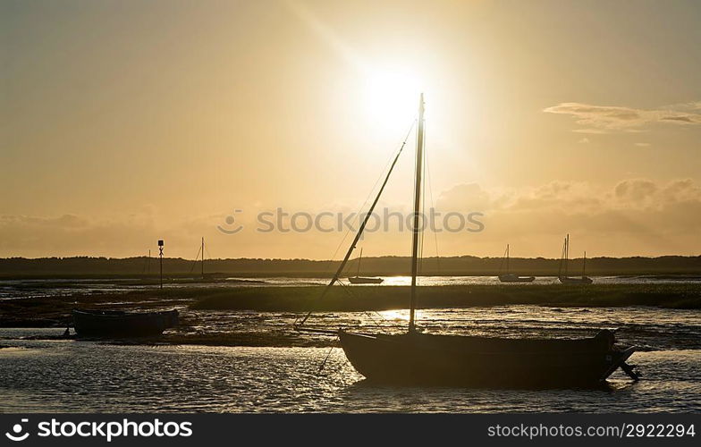 Leisure boats at low tide in harbor during Summer sunset