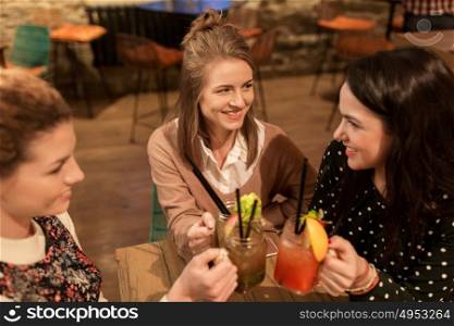 leisure, celebration, party, people and holidays concept - happy friends clinking drinks at restaurant. happy friends clinking drinks at restaurant