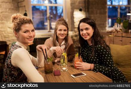 leisure, celebration, party, people and holidays concept - happy friends with drinks at restaurant