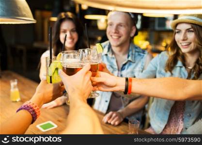 leisure, celebraton, friendship, people and holidays concept - happy friends clinking glasses at bar or pub