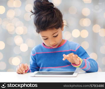 leisure, childhood, technology and people concept - little girl with tablet pc over holidays lights background