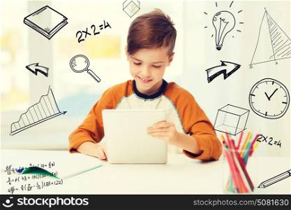 leisure, children, education, technology and people concept - smiling boy with tablet pc computer and notebook at home over mathematical doodles. smiling boy with tablet pc and notebook at home