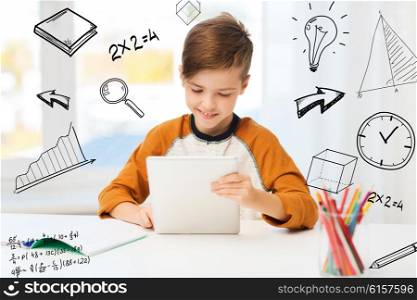 leisure, children, education, technology and people concept - smiling boy with tablet pc computer and notebook at home over mathematical doodles