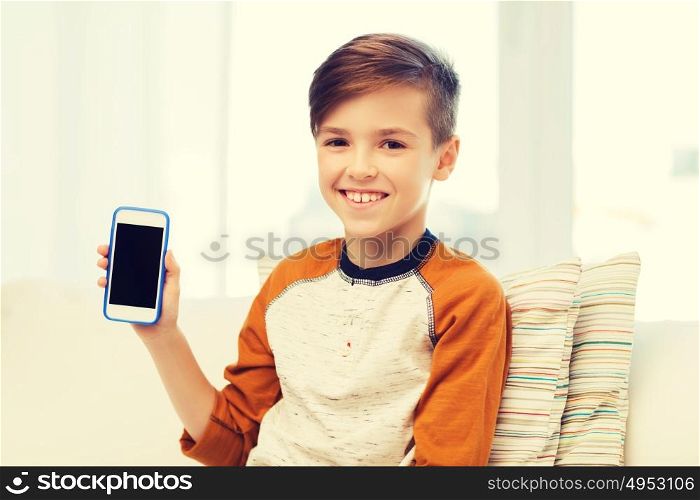 leisure, children, technology, advertisement and people concept - smiling boy with smartphone at home. smiling boy with smartphone at home