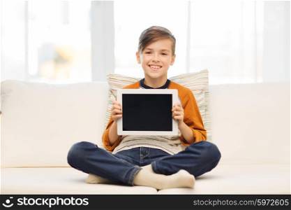 leisure, children, technology, advertisement and people concept - smiling boy with tablet pc computer at home