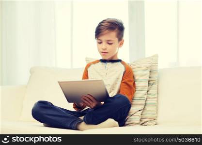 leisure, children, technology and people concept - boy with tablet pc computer at home. boy with tablet computer at home