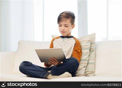 leisure, children, technology and people concept - boy with tablet pc computer at home