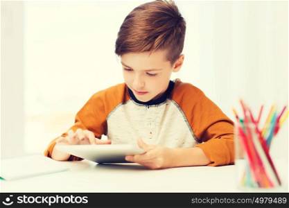 leisure, children, technology and people concept - close up of boy with tablet pc computer at home. close up of boy with tablet pc computer at home