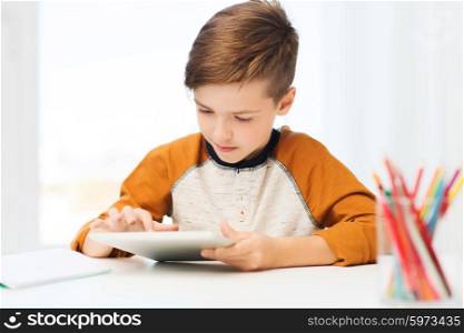 leisure, children, technology and people concept - close up of boy with tablet pc computer at home
