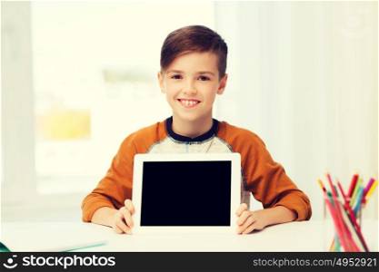 leisure, children, technology, education and people concept - smiling boy showing empty tablet pc computer screen at home. smiling boy showing tablet pc blank screen at home