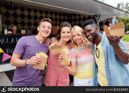 leisure, eating and people concept - happy friends with wok and burger at food truck. happy friends with wok and burger at food truck