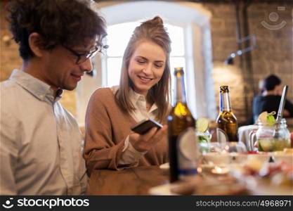 leisure, eating, food and drinks, people and holidays concept - happy couple with drinks at cafe or bar. happy couple with drinks at cafe or bar