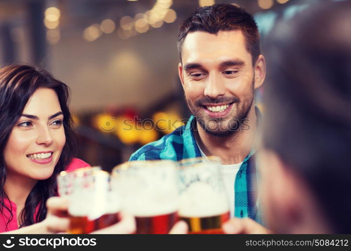 leisure, eating, food and drinks, people and holidays concept - smiling friends having dinner and drinking beer at restaurant or pub. friends dining and drinking beer at restaurant. friends dining and drinking beer at restaurant