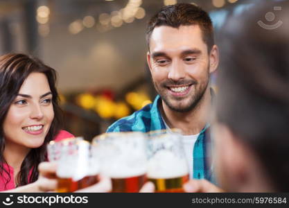 leisure, eating, food and drinks, people and holidays concept - smiling friends having dinner and drinking beer at restaurant or pub