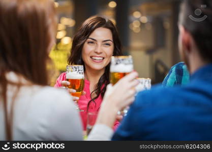 leisure, eating, food and drinks, people and holidays concept - smiling friends having dinner and drinking beer at restaurant or pub