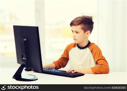leisure, education, children, technology and people concept - boy with computer at home. boy with computer at home