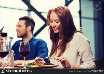 leisure, food and drinks, people and holidays concept - happy couple having dinner at restaurant. happy couple having dinner at restaurant. happy couple having dinner at restaurant