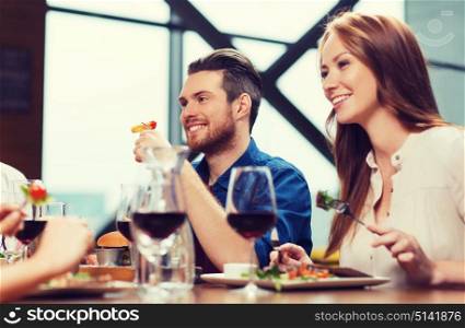 leisure, food and drinks, people and holidays concept - happy couple having dinner at restaurant. happy couple having dinner at restaurant
