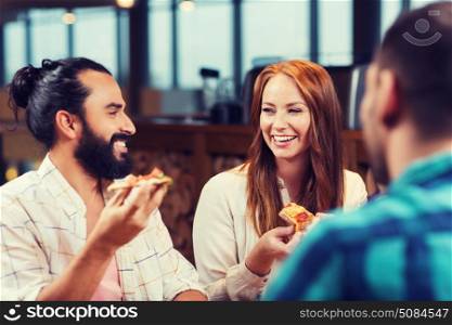 leisure, food and drinks, people and holidays concept - smiling friends eating pizza and drinking beer at restaurant or pub. friends eating pizza with beer at restaurant. friends eating pizza with beer at restaurant