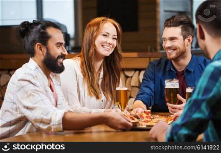 leisure, food and drinks, people and holidays concept - smiling friends eating pizza and drinking beer at pizzeria or pub