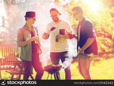 leisure, food, people, friendship and holidays concept - happy friends cooking meat on barbecue grill and drinking beer at summer outdoor party. friends drinking beer at summer barbecue party