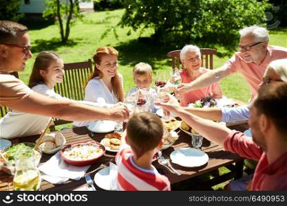 leisure, holidays and people concept - happy family having festive dinner or summer garden party and celebrating. happy family having dinner or summer garden party. happy family having dinner or summer garden party