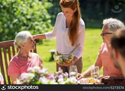 leisure, holidays and people concept - happy family having festive dinner or summer garden party. happy family having dinner or summer garden party