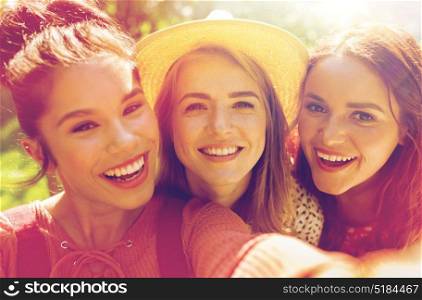 leisure, holidays and people concept - happy women or friends taking selfie at summer. happy women or friends taking selfie at summer